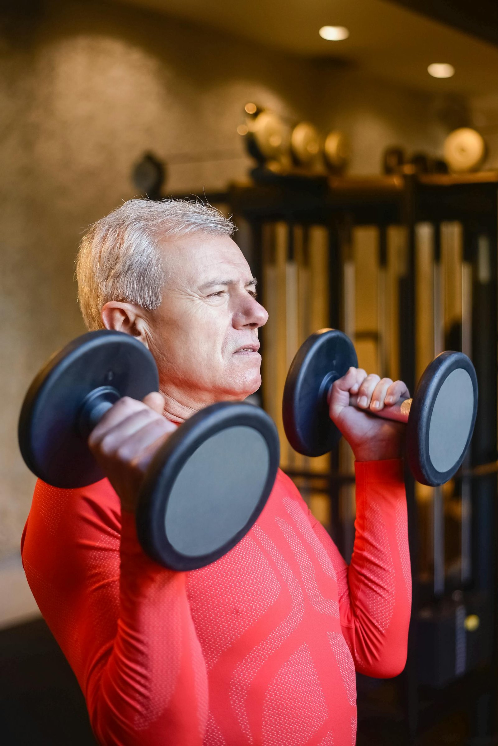 Elderly Man Lifting Two Heavy Dumbbells